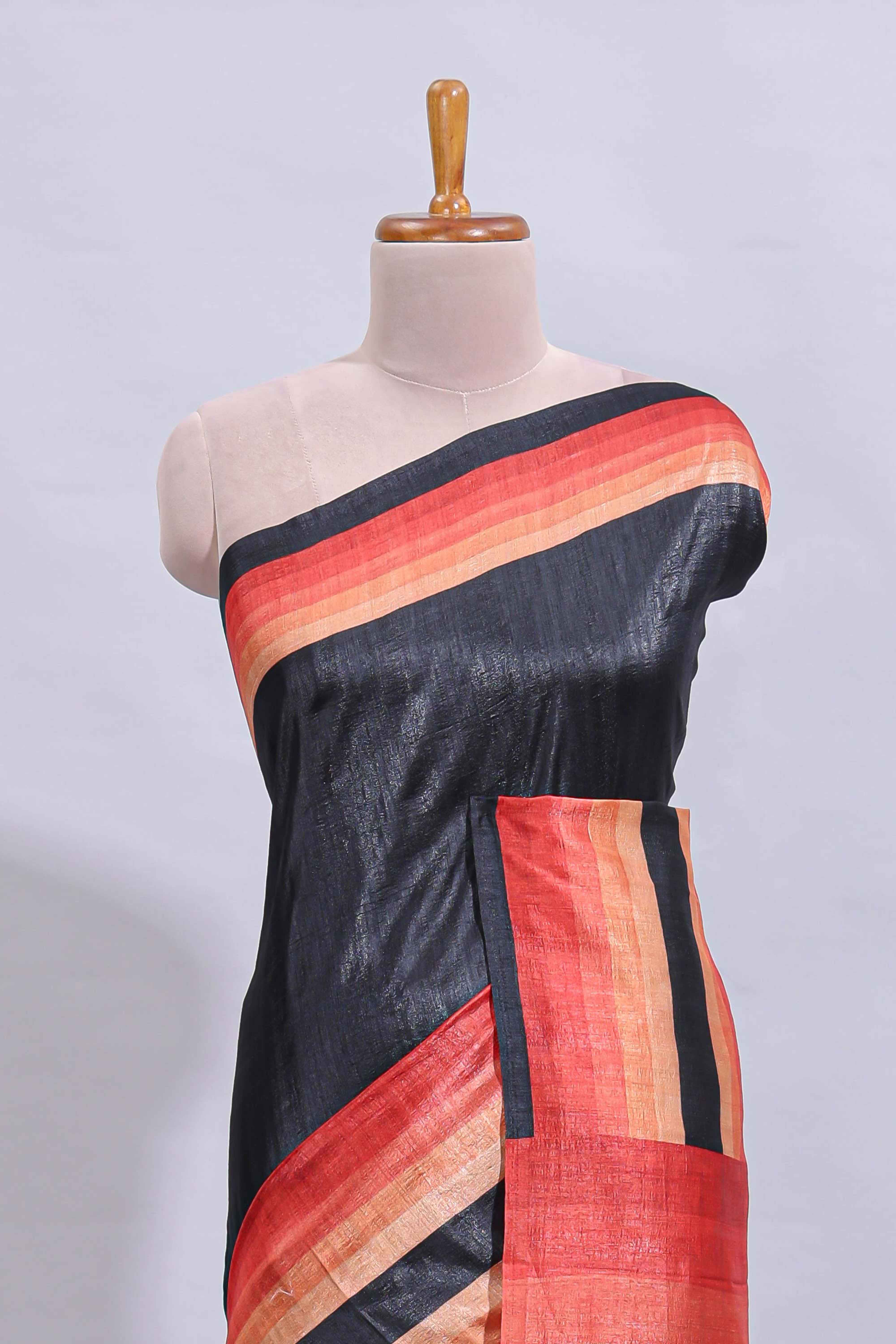 Black textured plain art tussar saree with contrast orange border and matching striped blouse - Image 3
