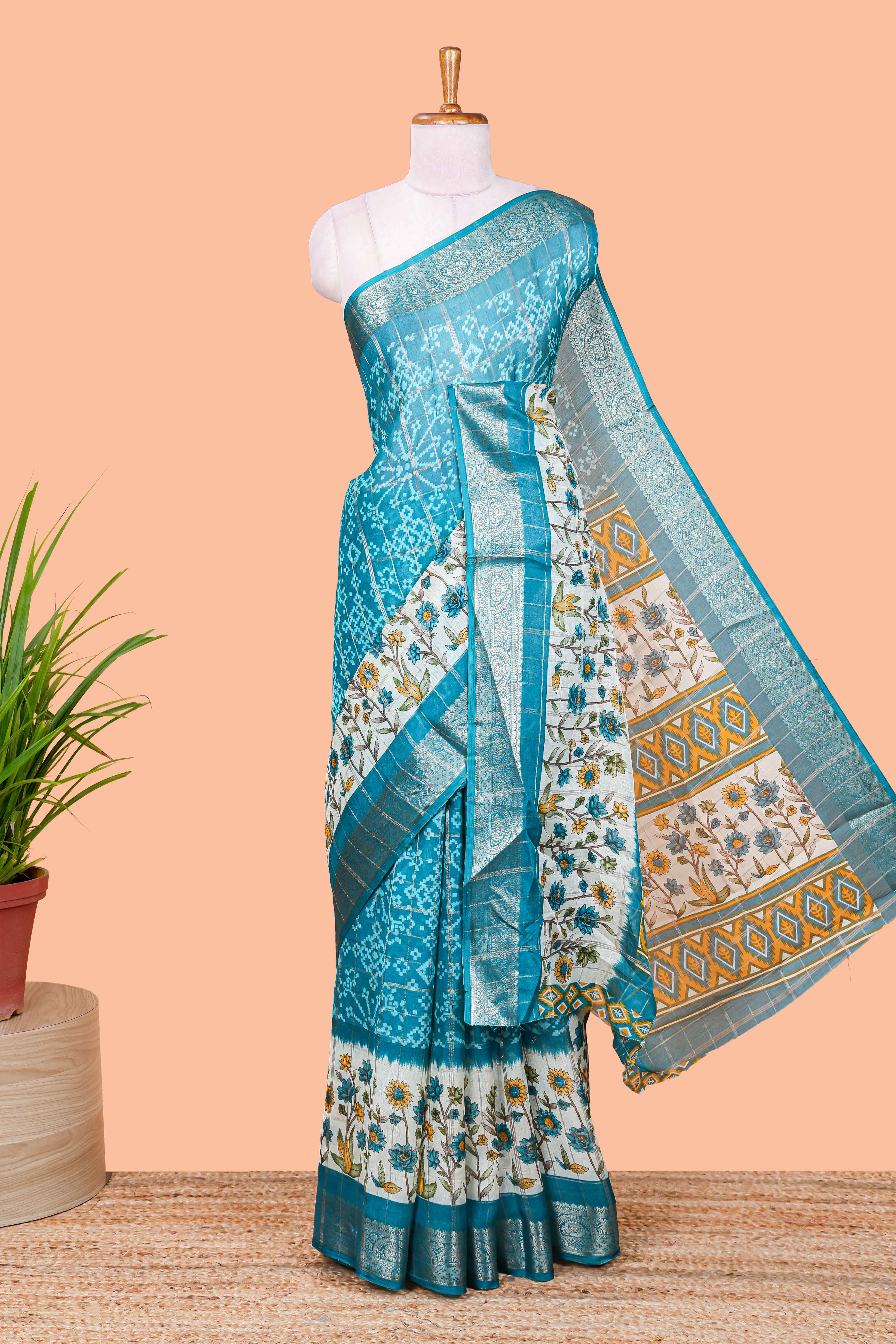 Blue floral ikkat style marsh georgette saree with zari border and contrast blouse