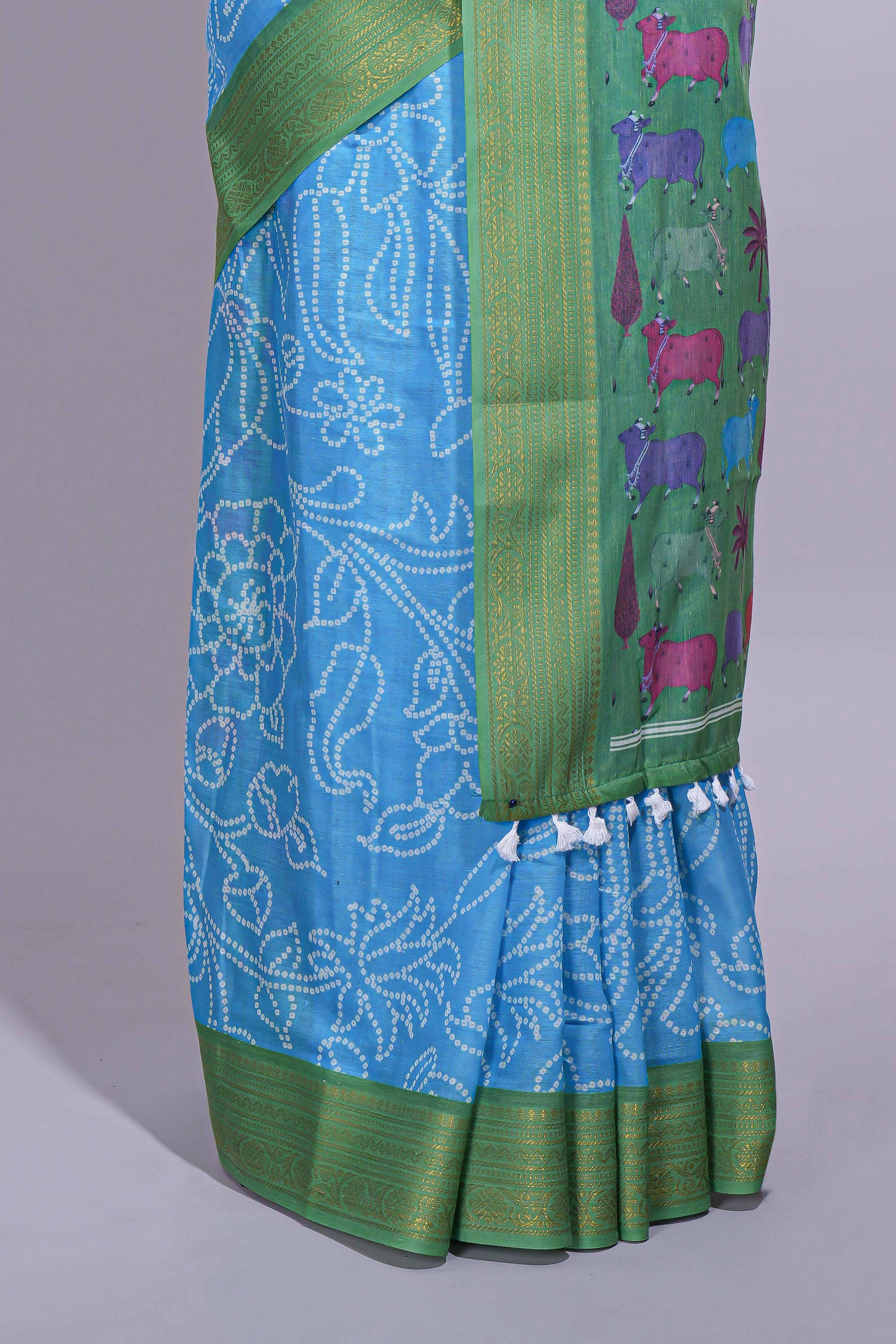 Blue linen saree with white dotted floral patterns with golden zari border and a multicolour pichwai motifs along with printed blouse - Image 4