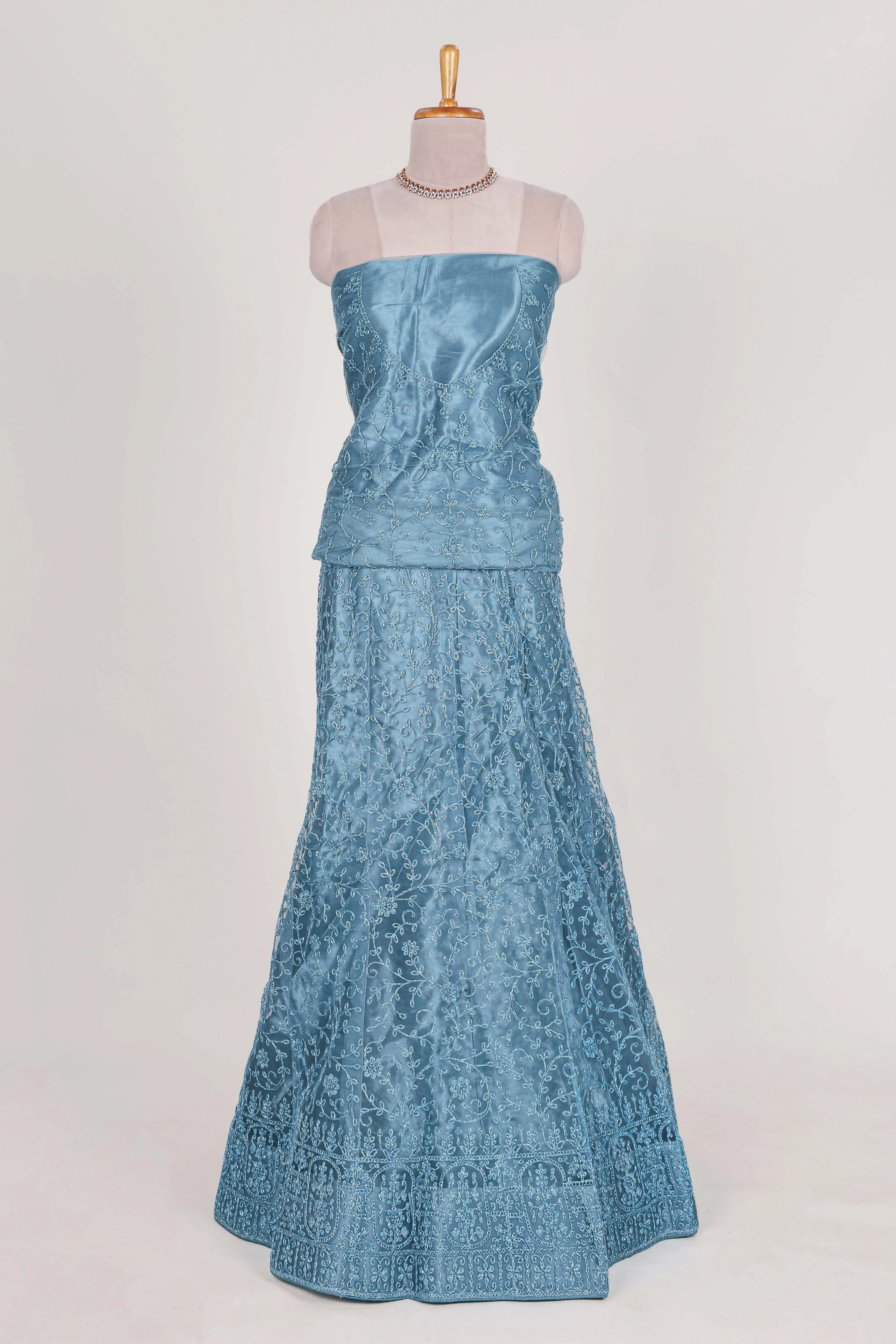 Blue colour net lehenga featuring delicate embroidery with a borderless design paired with a matching self shawl