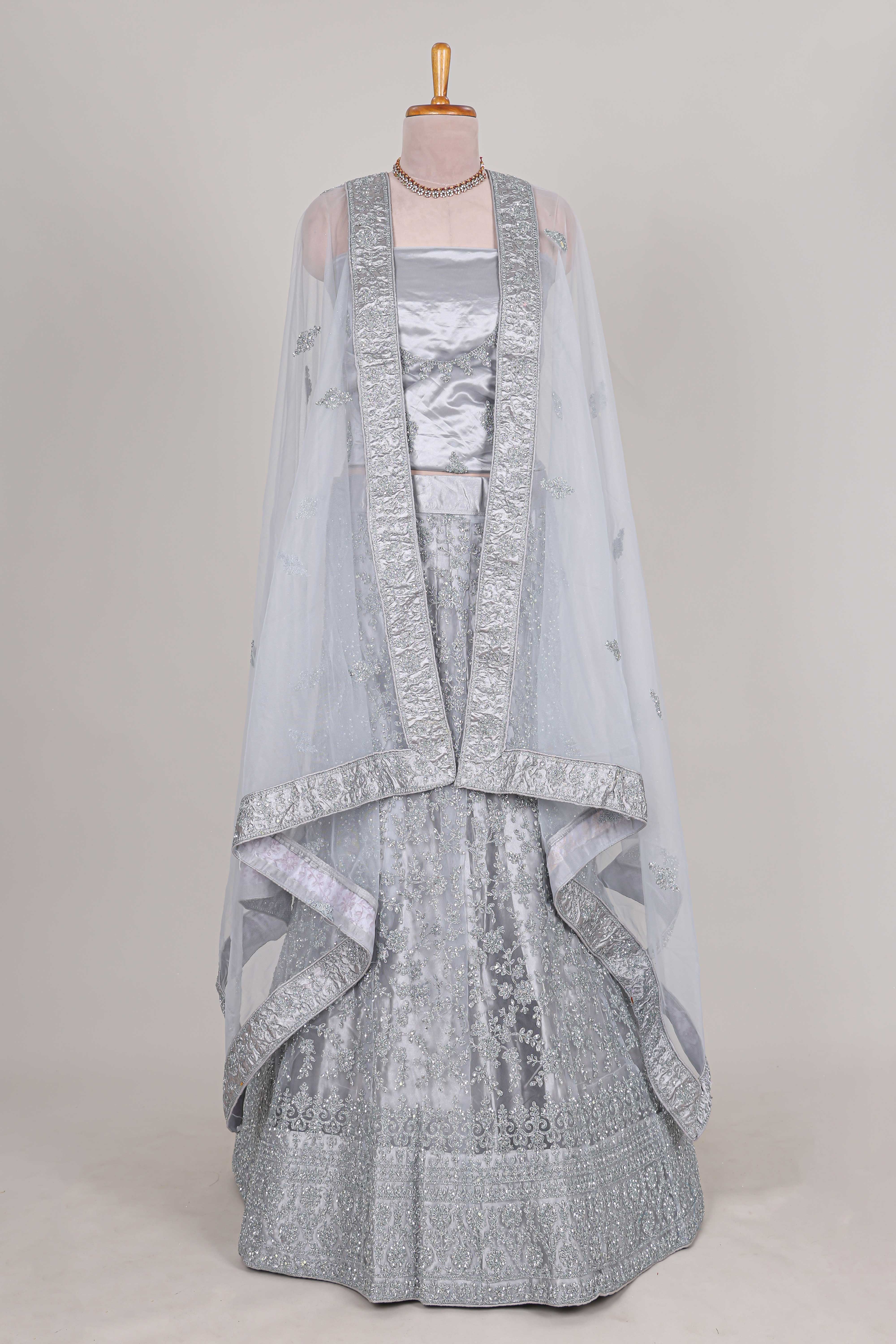 Silver colour net lehenga featuring delicate embroidery stone work with a borderless design paired with a matching self shawl - Image 3