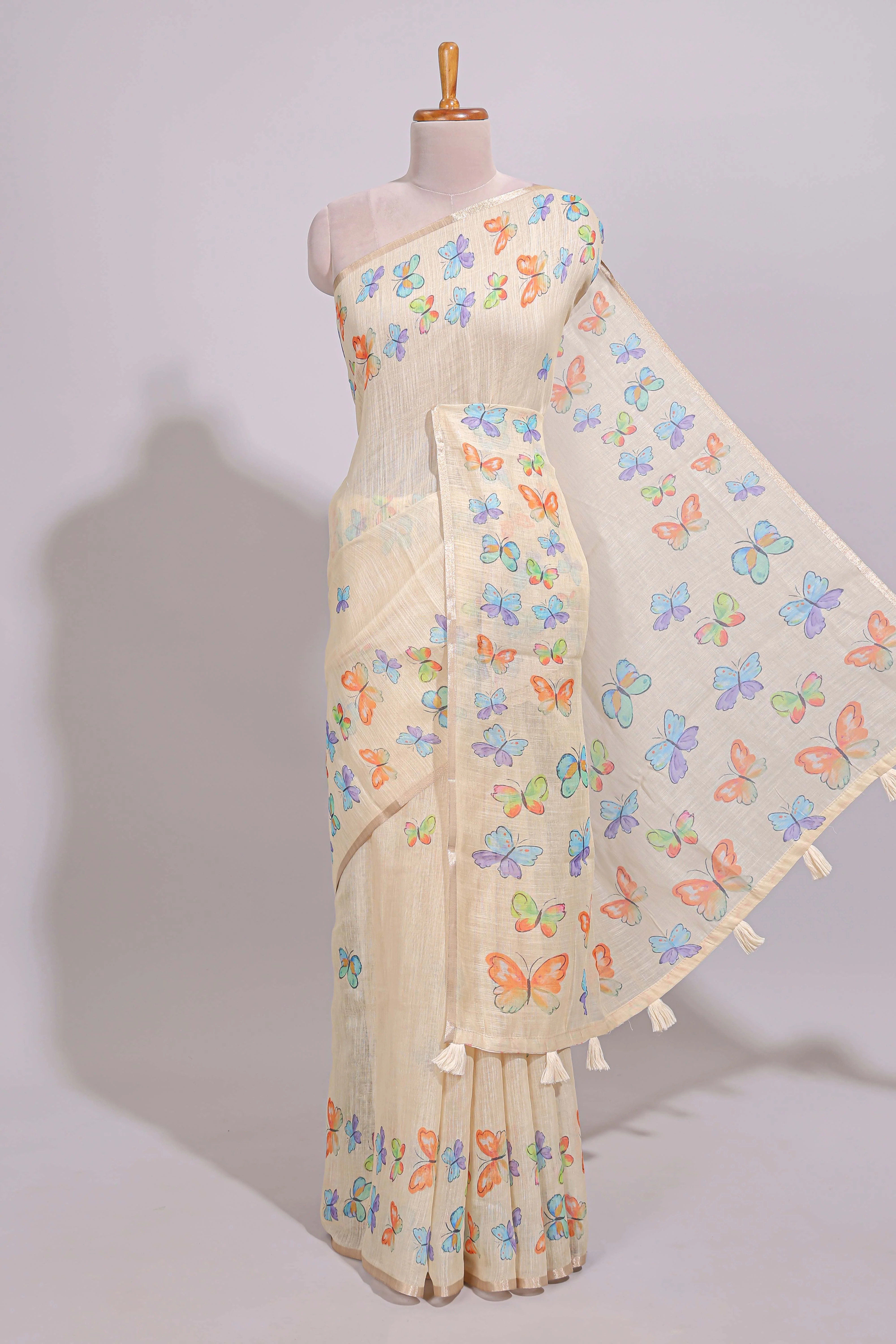 Cream butterfly motifs linen cotton saree with self zari border and matching printed blouse