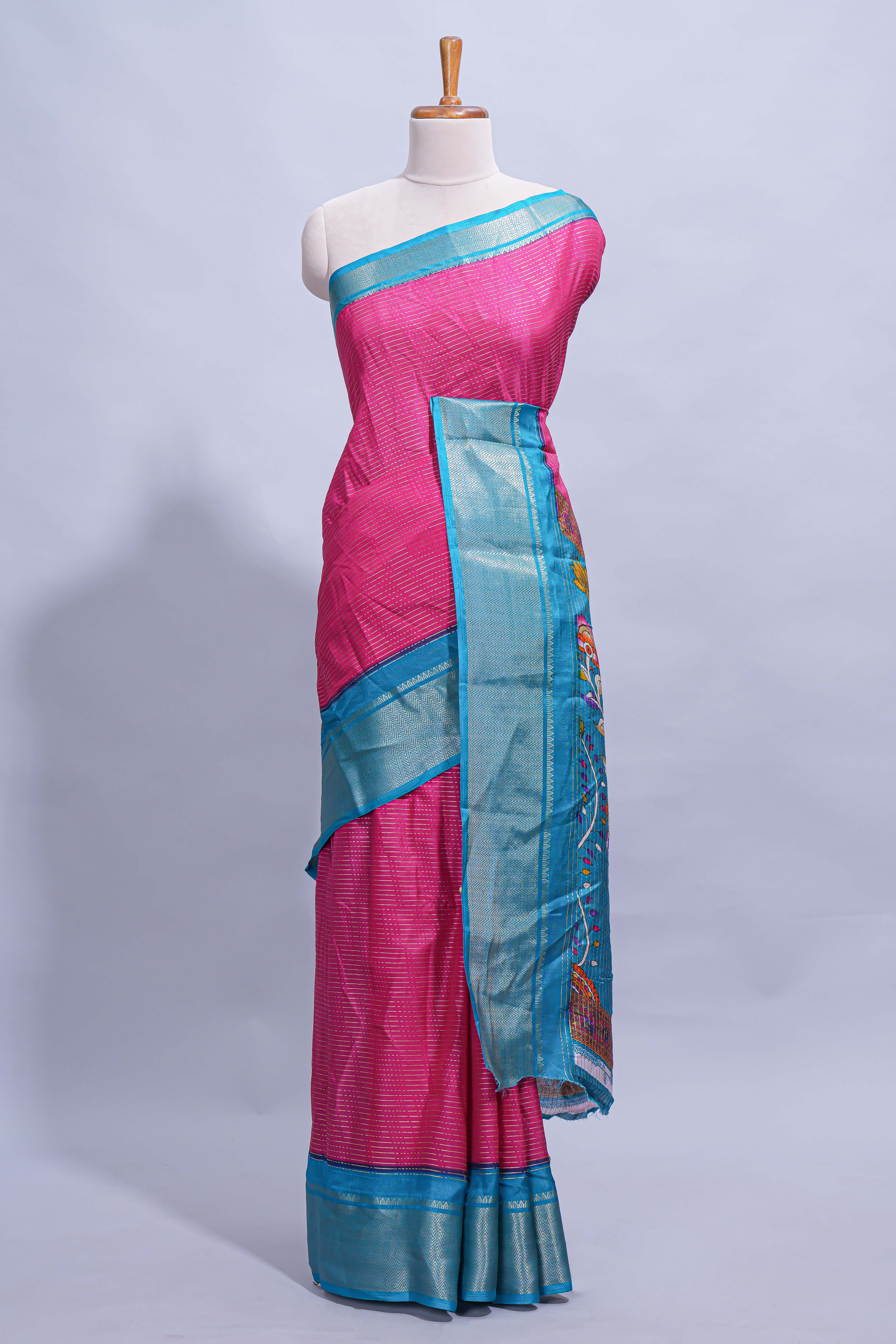 Pink dola silk saree with fine zari stripes contrast zari border and a rich peacock floral woven pallu along with printed contrast blouse