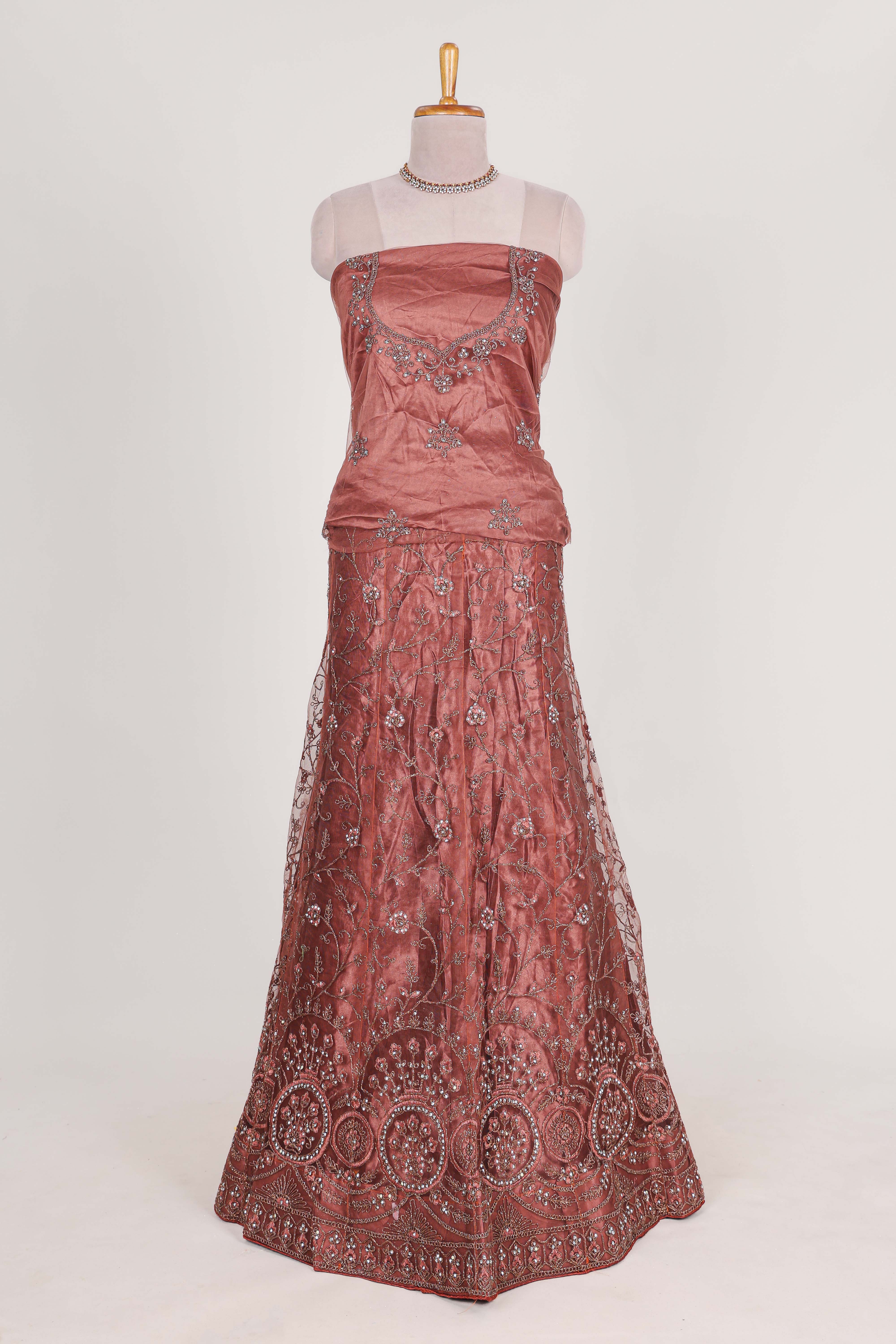 Brown net lehenga intricate embroidery and paired with a matching embroidered blouse - Image 2