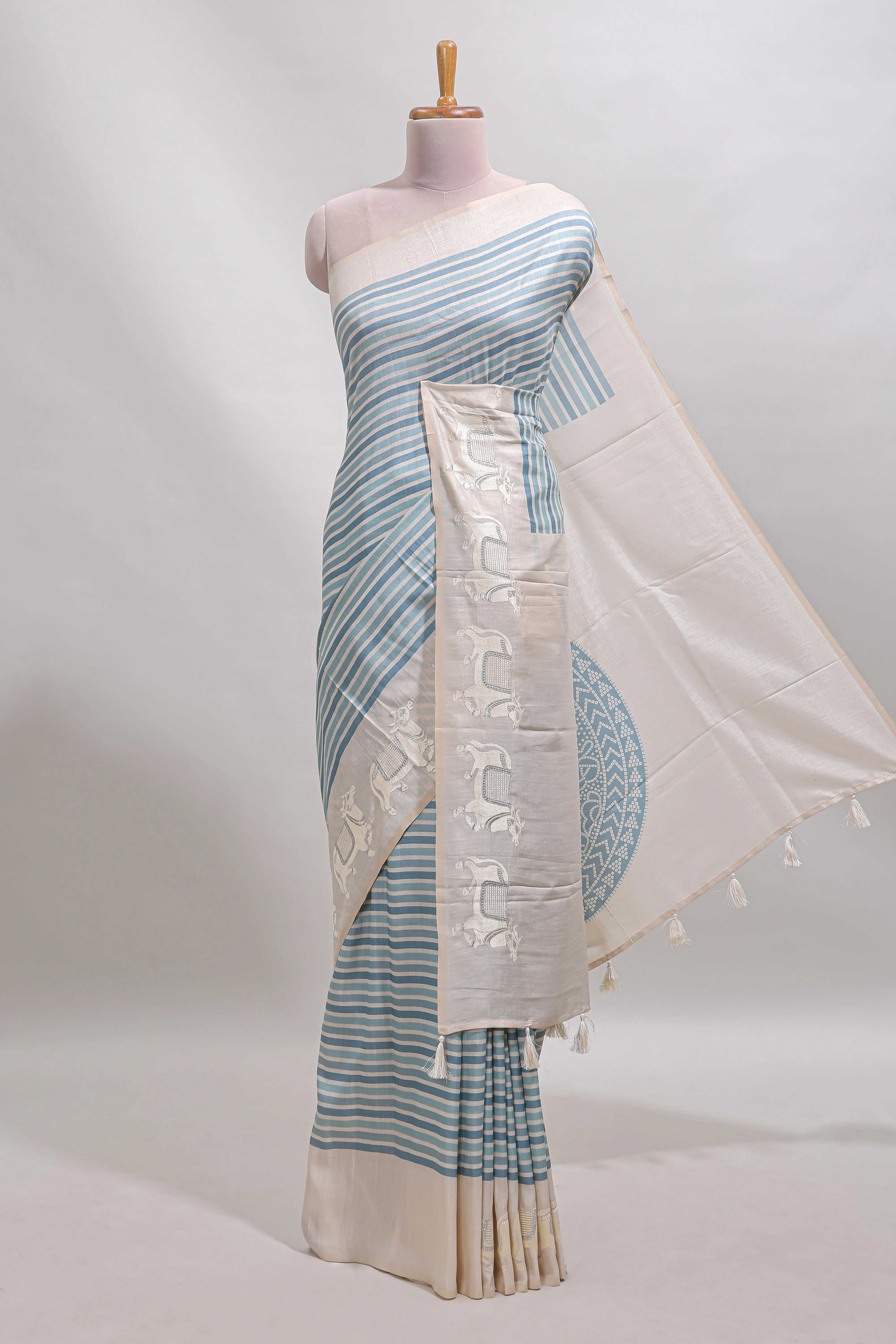 Cream striped tussar saree with contrast border and matching printed blouse