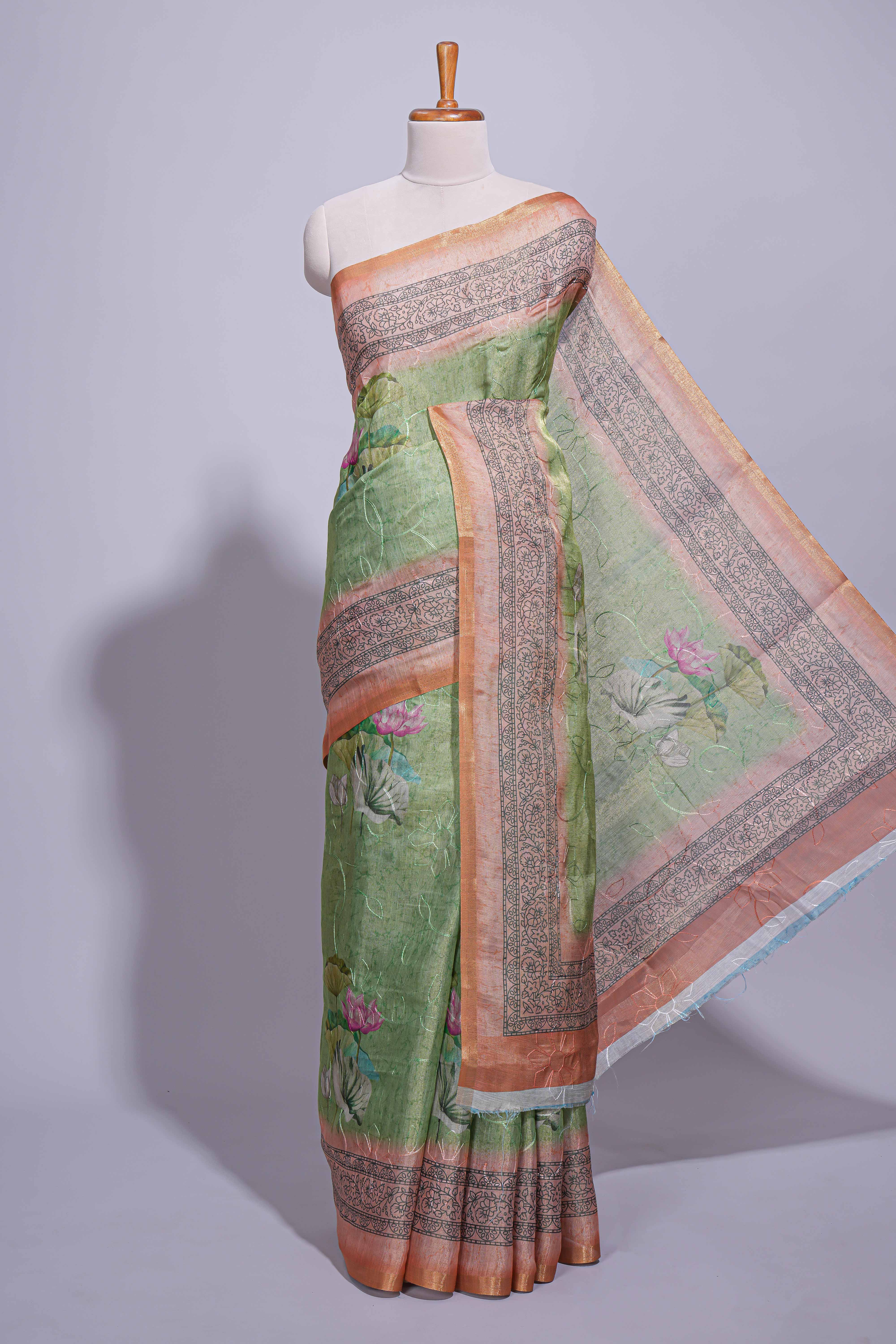 Soft green linen saree with floral print highlighted with a  floral pallu and zari border along with contrast blouse piece - Image 2