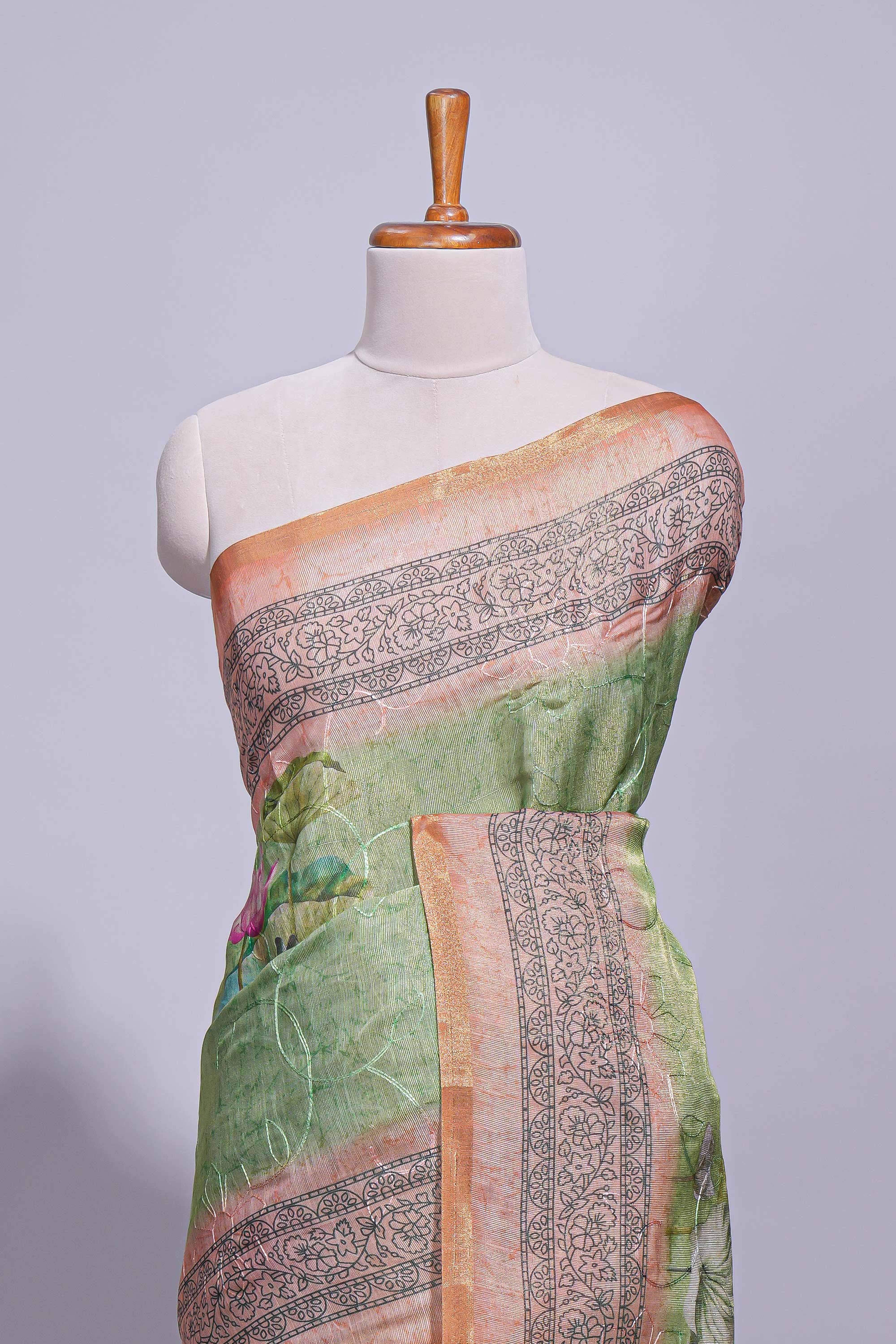 Soft green linen saree with floral print highlighted with a  floral pallu and zari border along with contrast blouse piece - Image 3