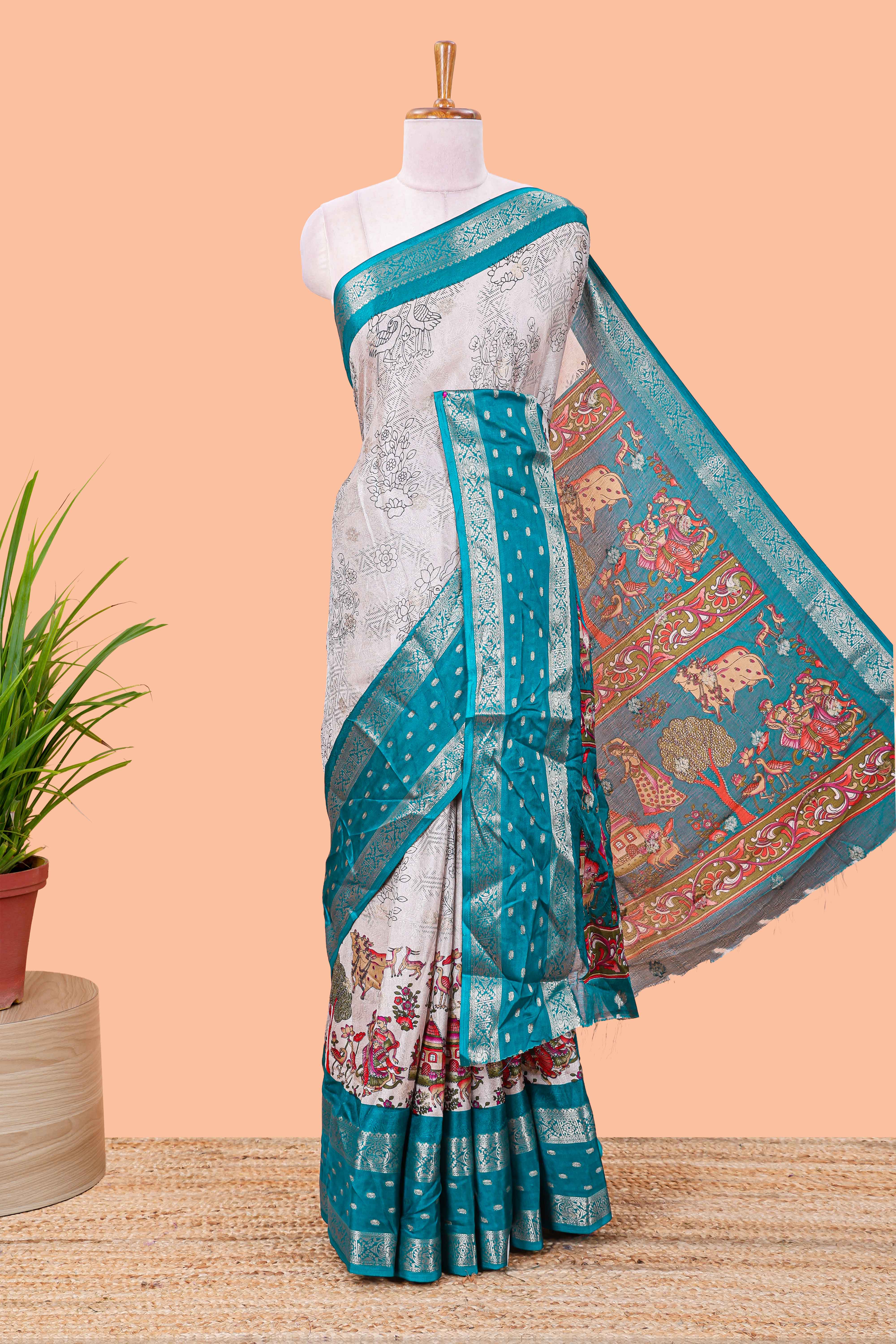 White Kalamkari style floral and crane birds print marsh georgette saree with turquoise green zari border and printed pallu